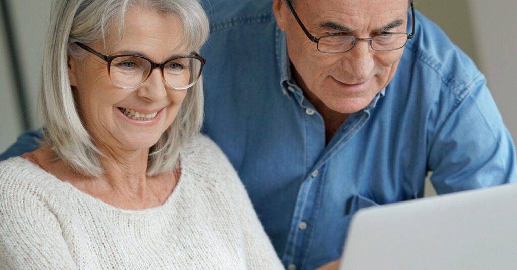 Middle aged couple reading from a computer screen