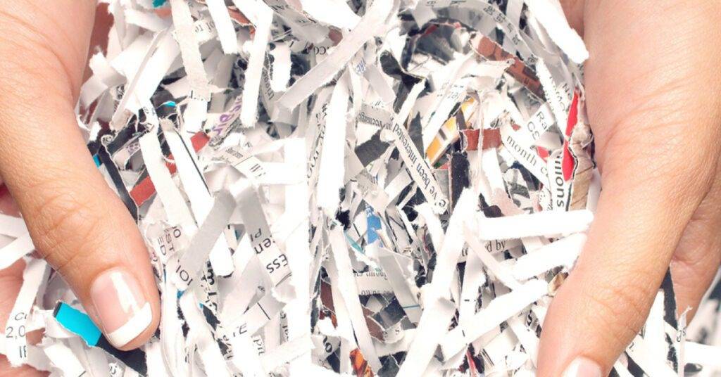 holding shredded paper