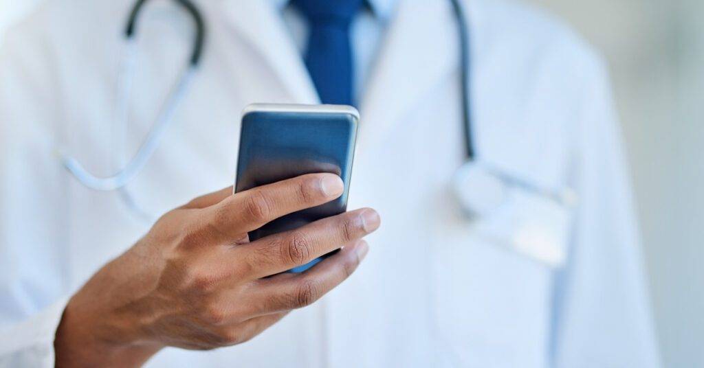 doctor reading from an iphone
