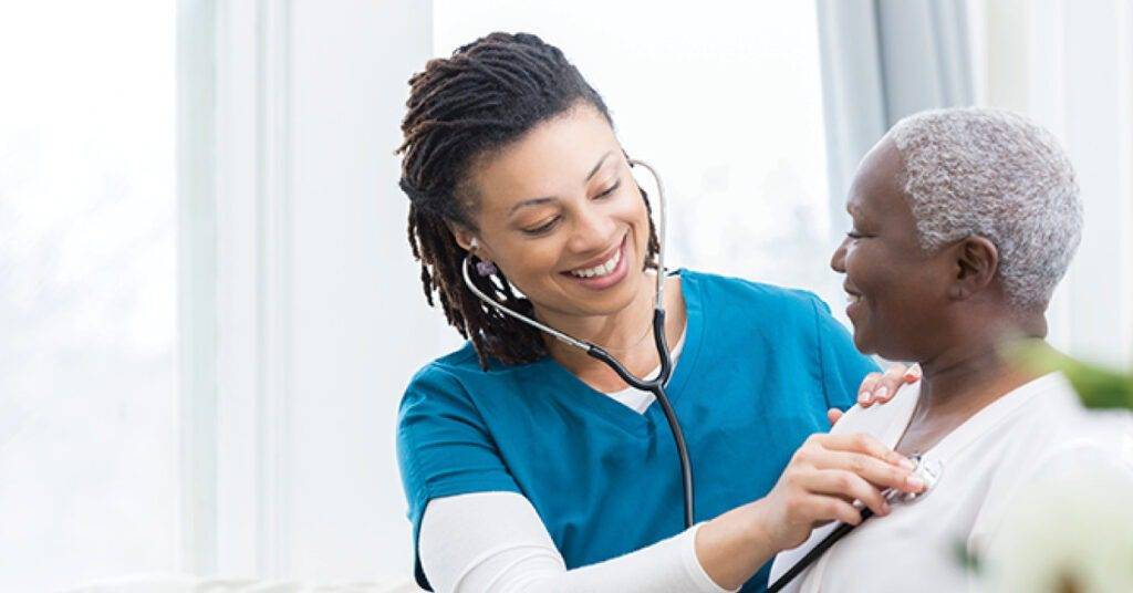female doctor examining patient using a stethoscope