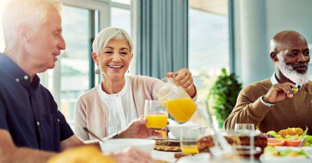 happy patients at a life plan community eating dinner