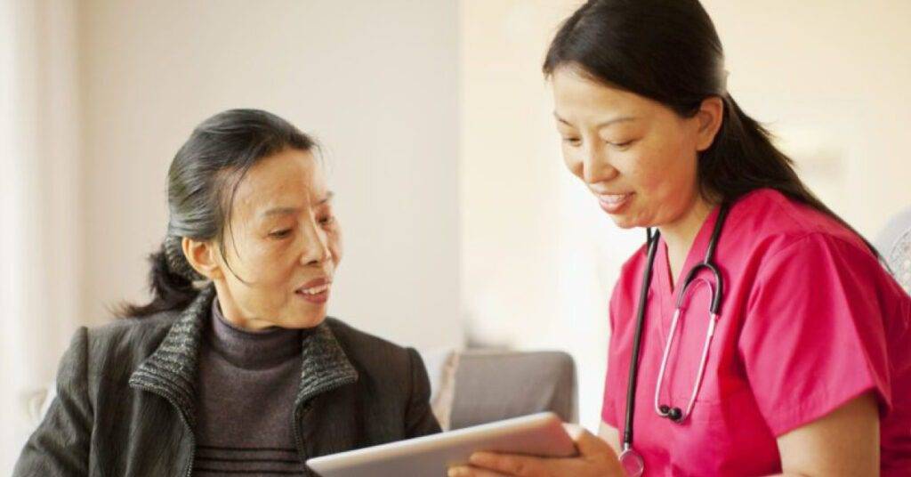 Asian doctor talking to patient