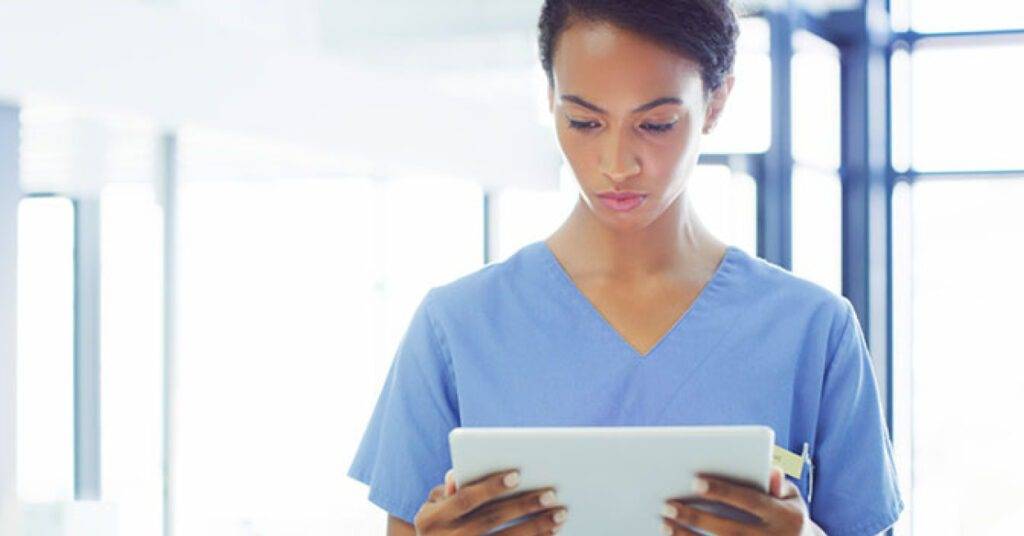 female medical professional reviewing data on tablet
