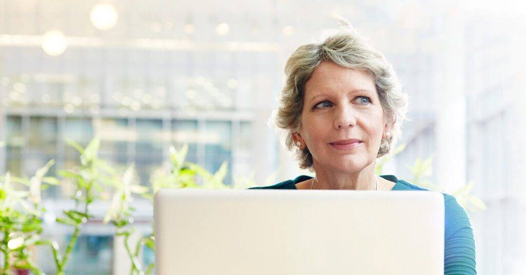 Female professional sitting in front of a computer