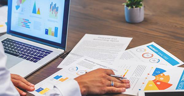 Looking at paperwork and spreadsheets